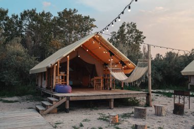 Glamping tent in the forest. Luxury tent sea view. Nature green tourism.