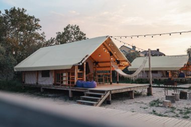 Glamping tent in the forest. Luxury tent sea view. Nature green tourism.