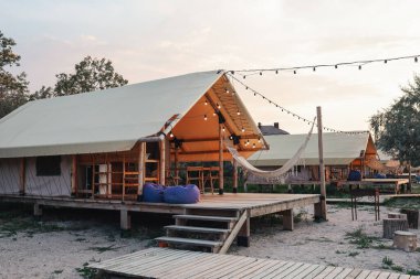 Glamping tent in the forest. Luxury tent sea view. Nature green tourism.