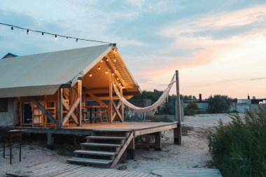 Glamping tent in the forest. Luxury tent sea view. Nature green tourism.