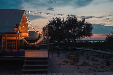 Glamping tent in the forest. Luxury tent sea view. Nature green tourism.