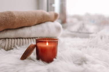 Candle on the windowsill. Autumn mood.