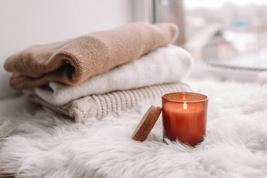 Candle on the windowsill. Autumn mood.