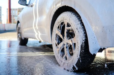 Car wheel wash. Car cleaning with water jet. Car rim or aloy washing close up.