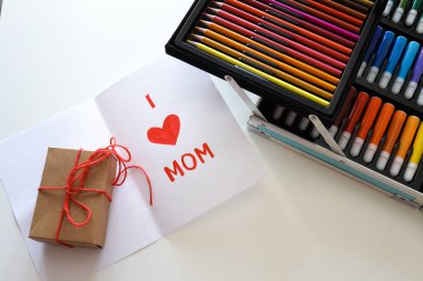 Handmade postcard I love you mom and mother's day gift close-up.