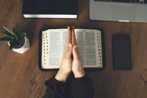 Woman praying by faith with computer laptop, Church services online concept, Online church at home concept, spirituality and religion.