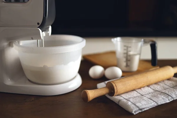 Closeup of a table in a home kitchen with a mixer and products for desserts. Preparing for the preparation of food.