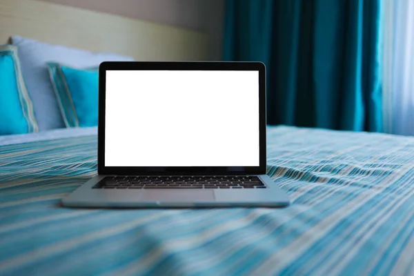 Mock up Blank screen laptop on the bed for advertising and text.
