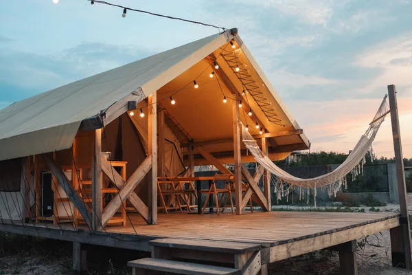 Glamping tent in the forest. Luxury tent sea view. Nature green tourism.