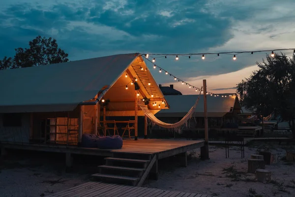 Glamping tent in the forest. Luxury tent sea view. Nature green tourism.