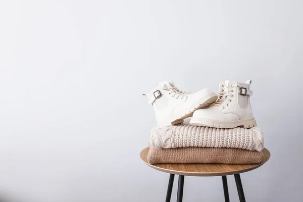 Stack Sweaters Boots Wooden Table Place Text Advertising — Fotografia de Stock