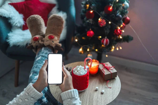 Mock up phone with place for your text on a cozy christmas background.