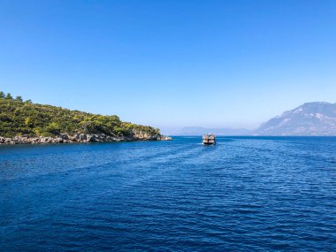 Beautiful sea view, sailboats far away in the sea in sunny day, natural background, amazing summer adventure.