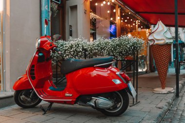 Red motorcycle at the entrance to the cafe. Atmospheric street photo