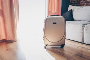 Suitcase in a bright modern apartment