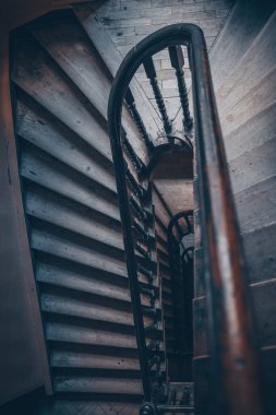 High angle above view down of old vintage staircase winding spiral in Lviv, Ukraine, Europe with nobody architecture dark low-key abstract pattern