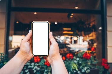 Phone with a screen on the background of a glowing store