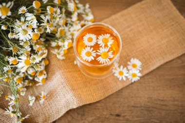 Glass cup of chamomile tea on the table