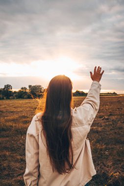 Girl at sunset enjoying nature