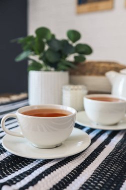 Two cups of tea, tea drinking in Scandinavian cuisine. Beautiful cozy home interior photography.