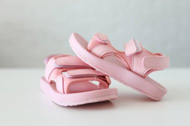 Baby pink sandals on a white background. Fashionable children's shoes for children.