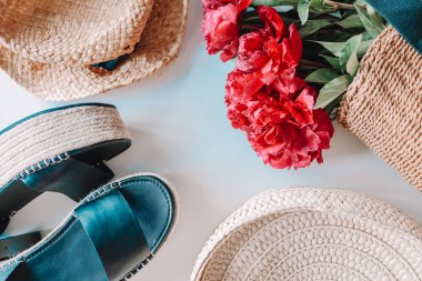 Women's set of summer things. Wicker bag, hat and flat lay sandals.