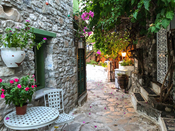 Narrow street in old town of Marmaris, Turkey . Beautiful scenic old ancient white houses with flowers. Popular tourist vacation destination
