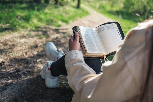Girl with the Bible in nature. beautiful christian picture.