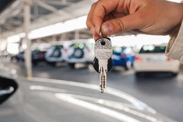 Keys in hand, car in the parking lot.