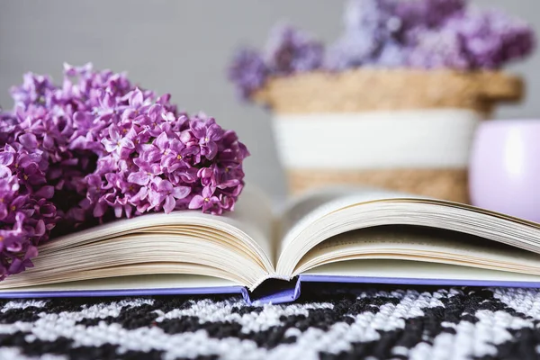 Wicker Basket Lilacs Candle Open Book Table Good Morning Concept — стоковое фото