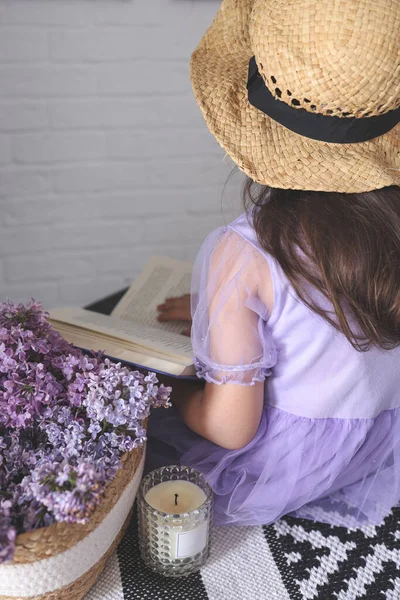 A girl in a hat reads a book, aesthetic retro photography.