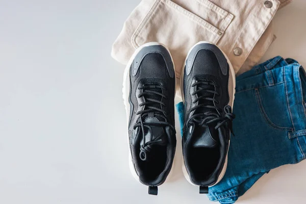 Stylish Men Clothing Flat Lay Black Sneakers Jacket Jeans White — стоковое фото