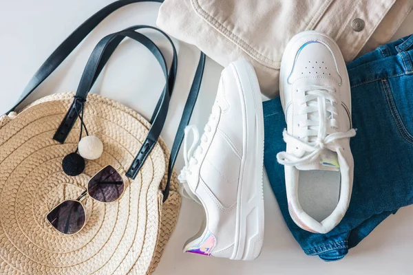 Stylish Women Clothing Flat Lay White Sneakers Wicker Bag Sunglasses — 스톡 사진