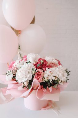Bouquet of peonies and balloons, greeting card with the holiday. Birthday, Valentine's day, March 8.