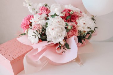 Bouquet of peonies and balloons, greeting card with the holiday. Birthday, Valentine's day, March 8.