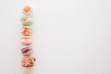 Macaroons on white background flat lay, space for text