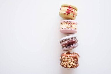 Macaroons on white background flat lay, space for text