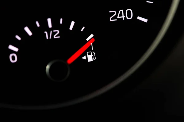 Close up of a fuel gauge showing a full fuel tank in a car, transportation with fossil fuel, efficiency of modern vehicles