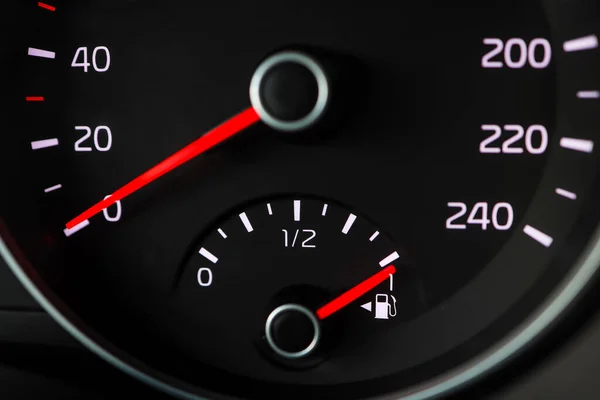 Close up of a fuel gauge showing a full fuel tank in a car, transportation with fossil fuel, efficiency of modern vehicles