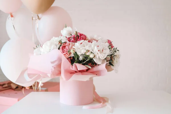 Bouquet of peonies and balloons, greeting card with the holiday. Birthday, Valentine's day, March 8.