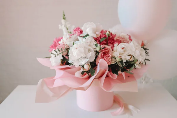 Bouquet of peonies and balloons, greeting card with the holiday. Birthday, Valentine\'s day, March 8.