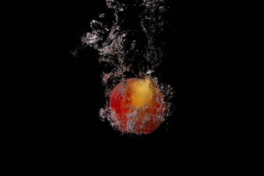 Taze meyve soğuk suya düşer ve hava kabarcıkları yüksek hızlı kameraya kısa süre içinde sağlıklı vejetaryen yaşam tarzını simgeler.