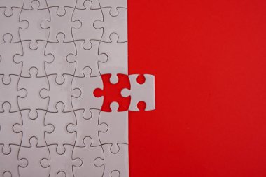 Conceptual photo of copyspace red background missing jigsaw puzzle. Image for motivation, inspiration and consultation, ideation concept..