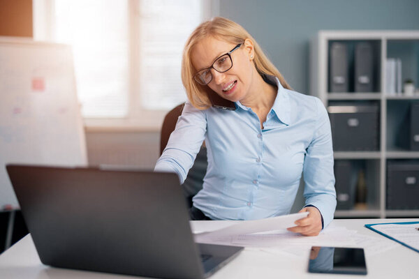 Multitasking of woman at office