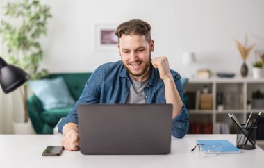 Man reading good news on laptop