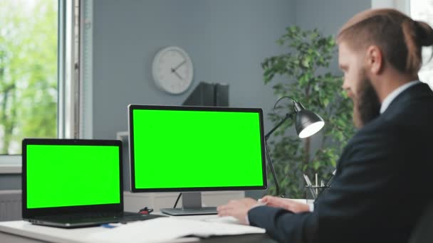 Человек с помощью компьютеров с зеленым экраном — стоковое видео