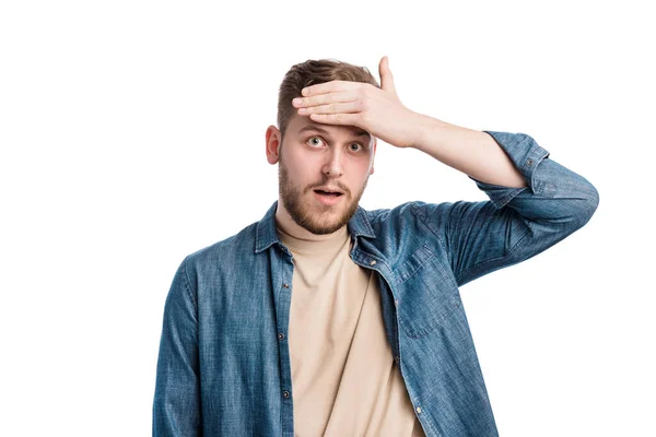 Portrait Puzzled Young Man Holding His Forehead Expressing Shocked Emotions — Stok fotoğraf