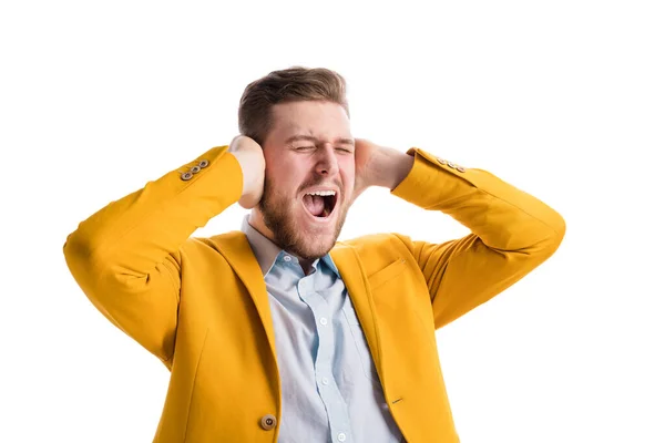 Portrait Emotional Young Man Angrily Screaming Covering Ears Hands White — Stok fotoğraf