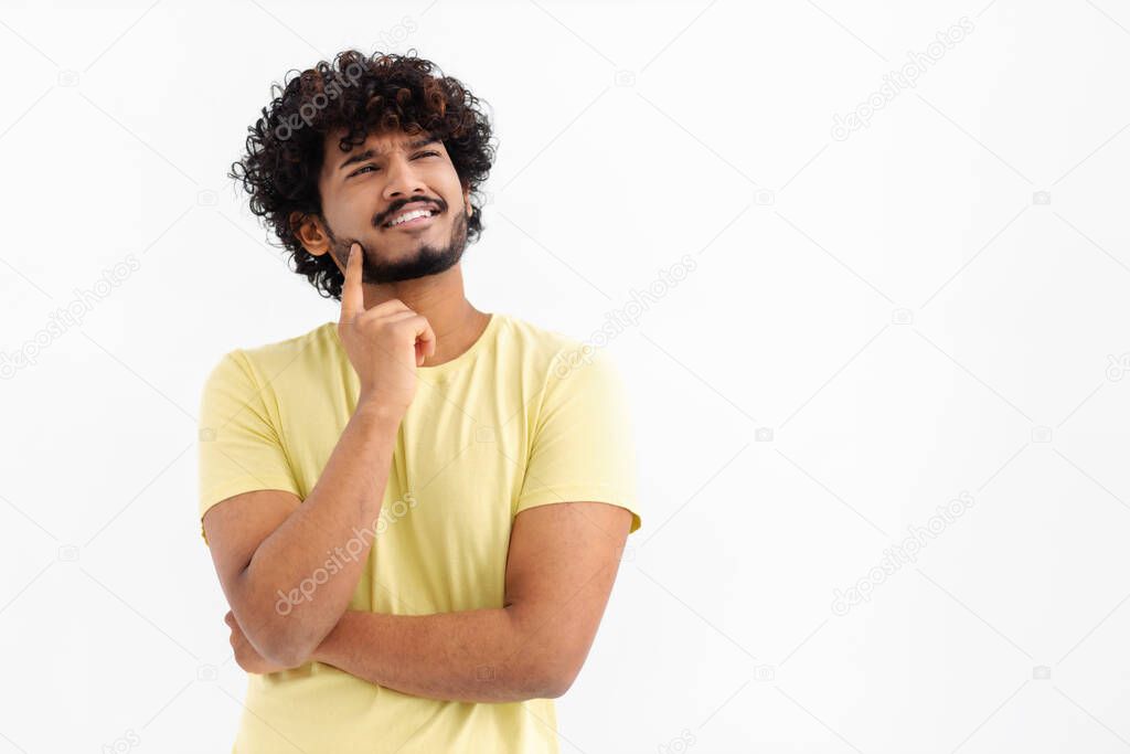 Thoughtful Asian male on white background contemplates about something, thinking an idea