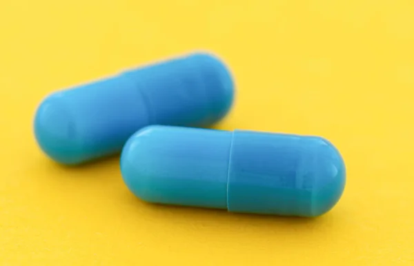 Blue Capsule Pills Yellow Background Close — Foto de Stock
